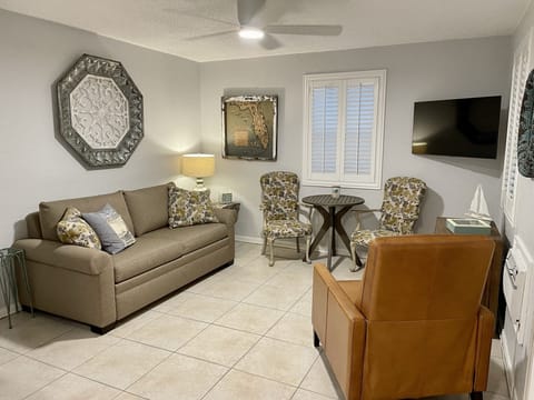 Living Room with sofa bed, bistro table, leather recliner & flat screen TV