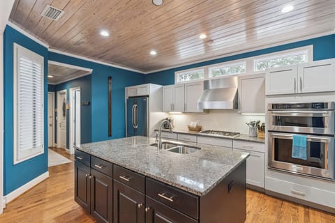 Your gourmet kitchen features granite counters, stainless appliances, and warm wood ceilings—perfect for preparing memorable meals during your stay.