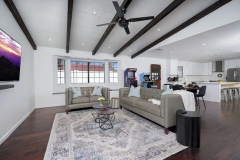 The living room is clean, modern and cozy. You and your family can watch TV on the 65" flatscreen + sound bar or enjoy the arcade games. The open concept allows everyone to spend time together.