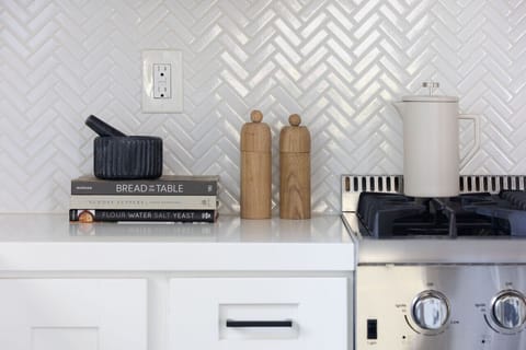Custom Herringbone tile, Quartz countertops and beautiful design perfect for inspiring any recipe.