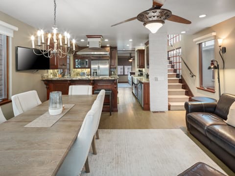 Elegant open-concept living space with cozy seating area with a leather sofa, perfect for relaxation.