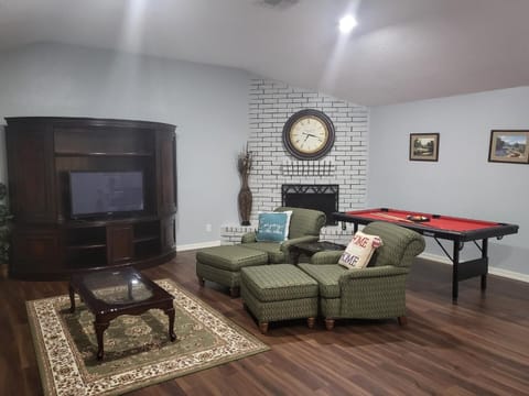 Spacious living room with pool table to enjoy for the entire family