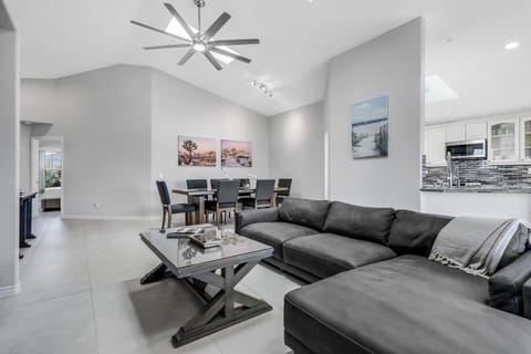 Living room area with abundant natural light from skylights and windows.