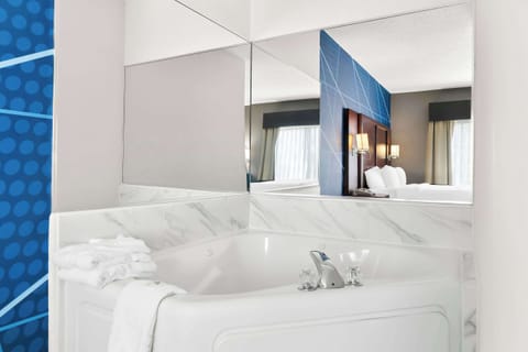 Premium bedding, desk, laptop workspace, blackout drapes