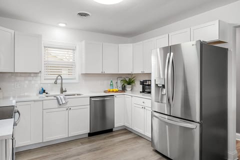 New kitchen with stove, microwave, dishwasher and fridge