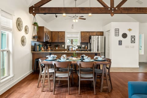 Dining spaces for 9 with six at the table and three at the counter.
