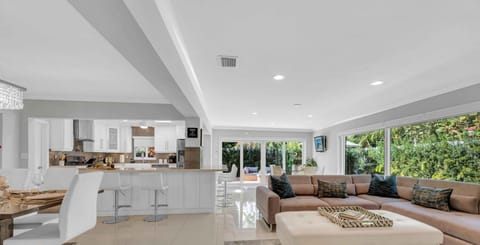 This modern coastal ranch style residence is ideal for tranquil relaxation and privacy with its lush garden and heated pool.