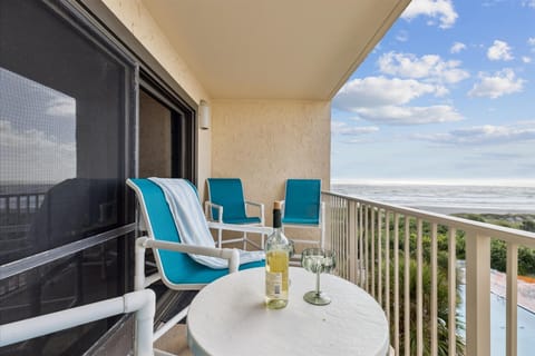 Private balcony with ocean views, featuring cozy seating to enjoy the scenery.
