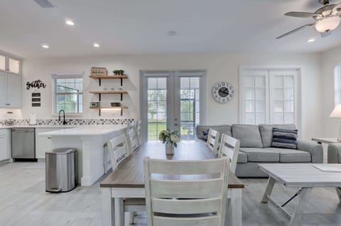 A View From the Dining Set Towards the Kitchen, Porch, Family Room and Den With Doors Closed in Back Right