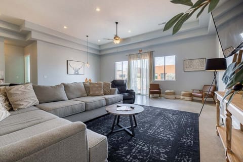 The living room is spacious and hosts a multitude of seating for everyone to congregate comfortably.