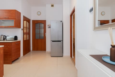 Another view of the kitchen, emphasizing its functionality and wooden design.

