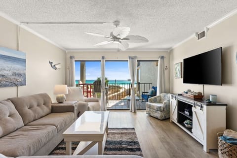 Cozy Living Room with Flat Screen TV, Plush Couch & Private Balcony Access with Ocean & Pool Views