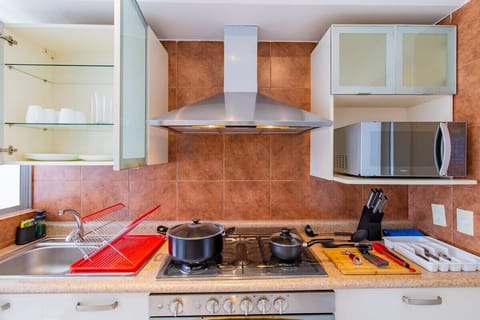 Fully equipped kitchen with appliances and utensils