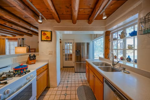 A kitchen with a stove and sink.