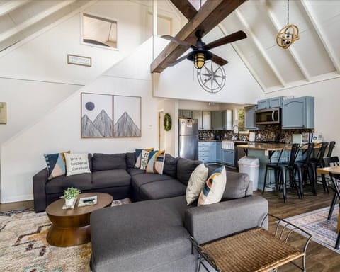 Spacious open layout perfect for gathering with family and friends, featuring vaulted ceilings, exposed beams and ample seating.
