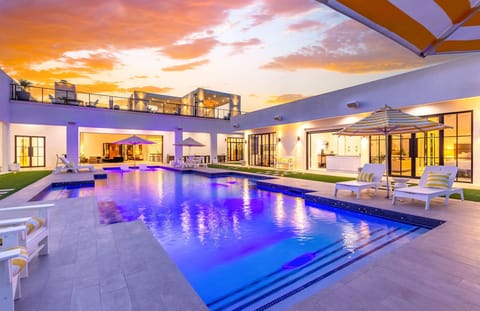 Sunset hits different here—pool glowing, sky on fire, and the whole patio made for late-night laughs and easy desert evenings.