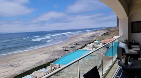 View from patio of the pools, hottubs, beach, and ocean.