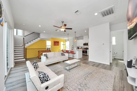 Modern and spacious living room for entertaining. Features Futon sofas