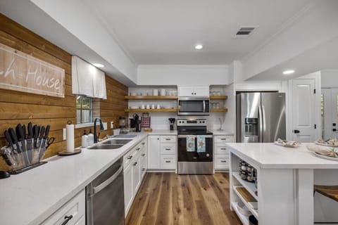 Fully updated kitchen with stainless appliances, quartz countertops, open shelving, and everything you need to cook family meals.