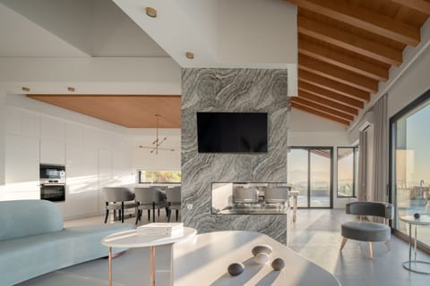 The lounge features two free-shape sofas, a 50’’ HDTV, Bluetooth speaker and ethanol fireplace.