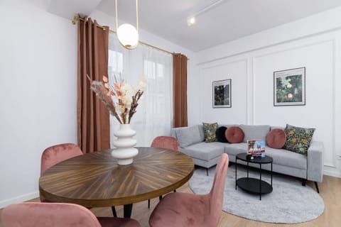 A cozy dining corner with a bouquet of flowers as a centerpiece.