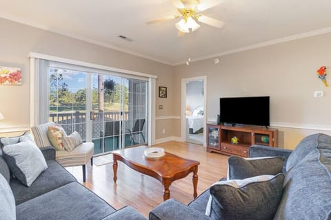 Sunny living room with sleeper sofa overlooking the golf course
