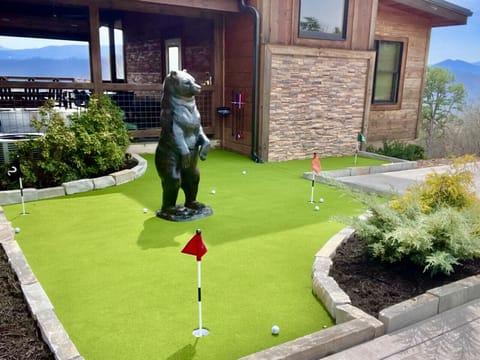 Hopefully the big black bear won`t get in the way of scoring a hole in one on the cabin`s new putting green!