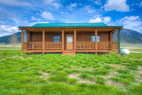The back covered porch offers a BBQ for easy cooking at the cabin. 