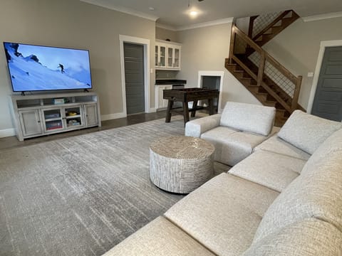 Downstairs den/playroom/game room with foosball table.