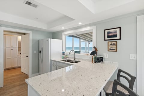 Kitchen with counter seating at the breakfast bar.