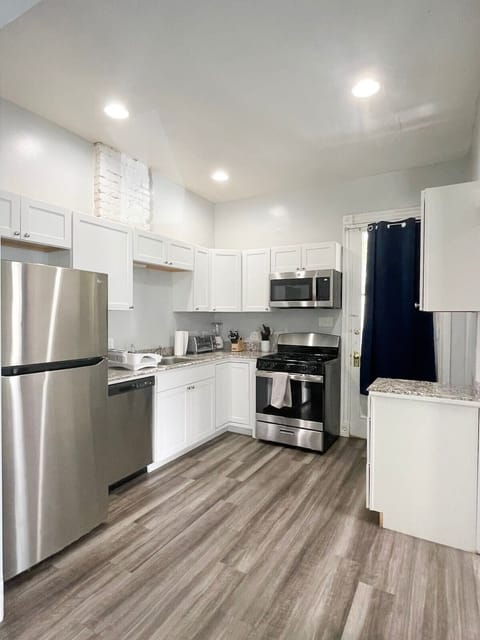 This fully equipped kitchen has everything you need to prepare meals, featuring modern appliances, cooking utensils, pots, pans, and all the essentials for a stress-free cooking experience.
