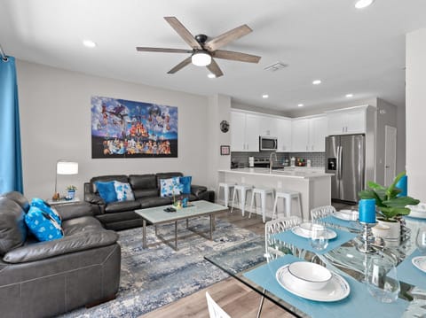 Open-concept living room flowing into fully equipped kitchen at Belle’s Villa