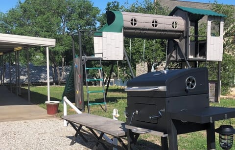 Small BBQ and Patio Play Area (note small lake view between lakehouses in back)