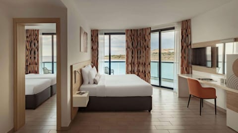 Family Room, Sea View | Minibar, in-room safe, blackout drapes, iron/ironing board