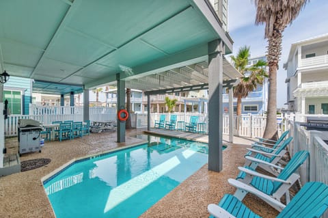 Your private pool oasis awaits with turquoise waters, covered seating, and tropical palms creating the perfect backdrop for relaxation.