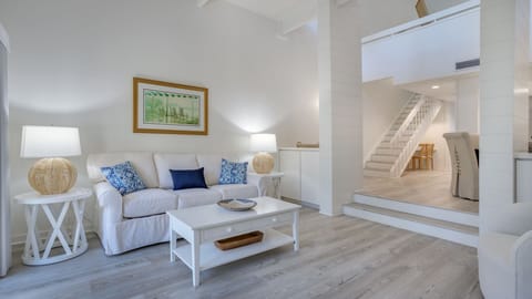 The open layout flows seamlessly toward the dining area and staircase, giving the space an open, connected feel without sacrificing comfort.