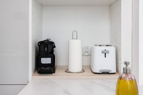 A modern utility corner featuring a washing machine, dryer, and minimalist design.
