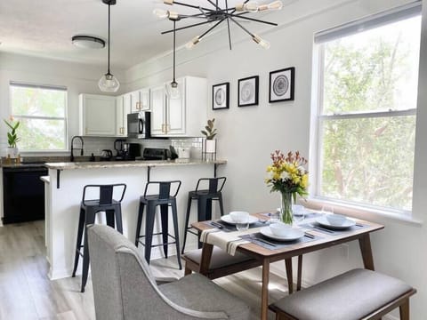 Gather for meals at this open dining space with plenty of natural light and easy access to the kitchen.