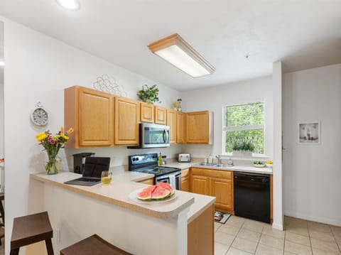 Fully stocked kitchen with modern appliances and bar seating—cook your favorite meals and feel right at home.