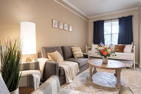 This living space is the definition of "cozy-chic." It has that warm, inviting glow that makes you want to drop your bags and immediately curl up with a book.