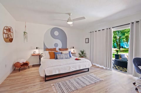 Modern Zen Sanctuary with Private Garden Access Find your balance in this thoughtfully curated bedroom featuring a custom Yin-Yang mural and minimalist design.