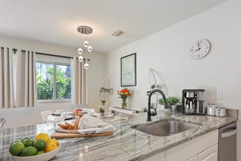 Our open-concept kitchen features stunning stone countertops and all the essentials—from the morning coffee maker to a spacious prep area for dinner.