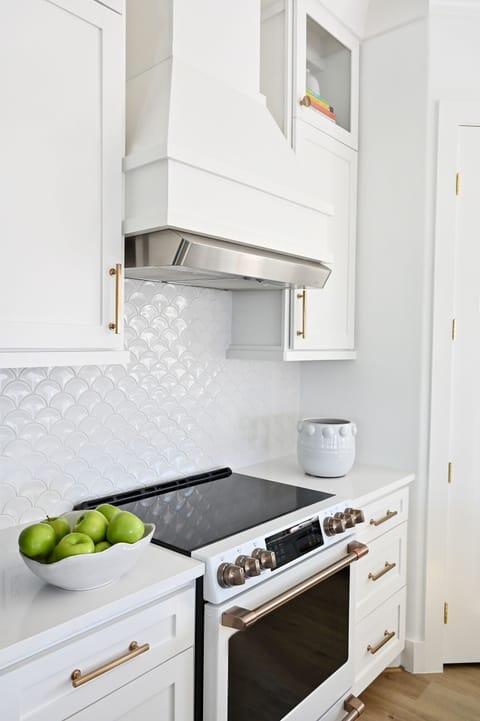 Cook top and full-size oven are located beside large pantry.