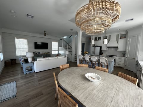 The living room, dining area and kitchen are all open with views of water.