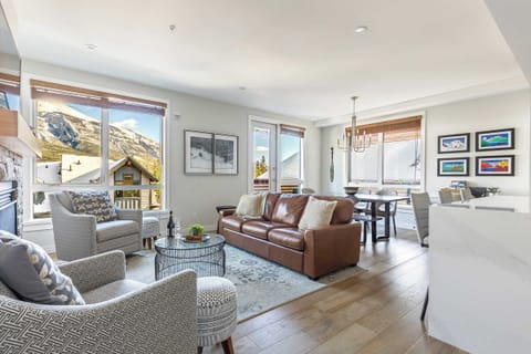 Living and dining area, including the door to the deck with BBQ and seating to admire those mountain views