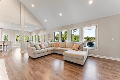 Living room with large sectional, TV & deck access.