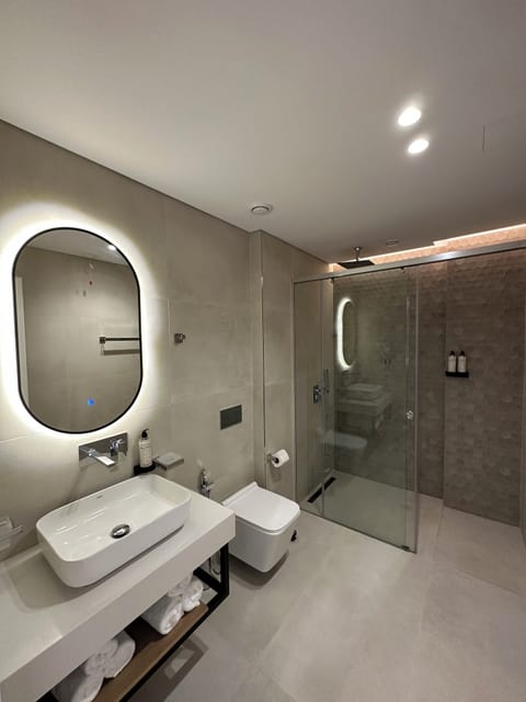 Shower, hair dryer, slippers, towels