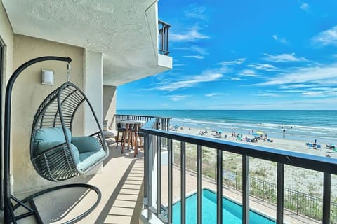 Large porch with a bistro set, hanging egg chair, chase lounge, and more . perfect views of the beach and pool.  