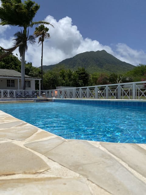 Pool with guest cottage and Nevis peak in background 