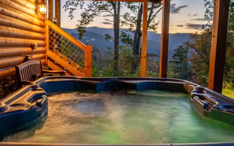 Relax in the private hot tub with peaceful Smoky Mountain views.